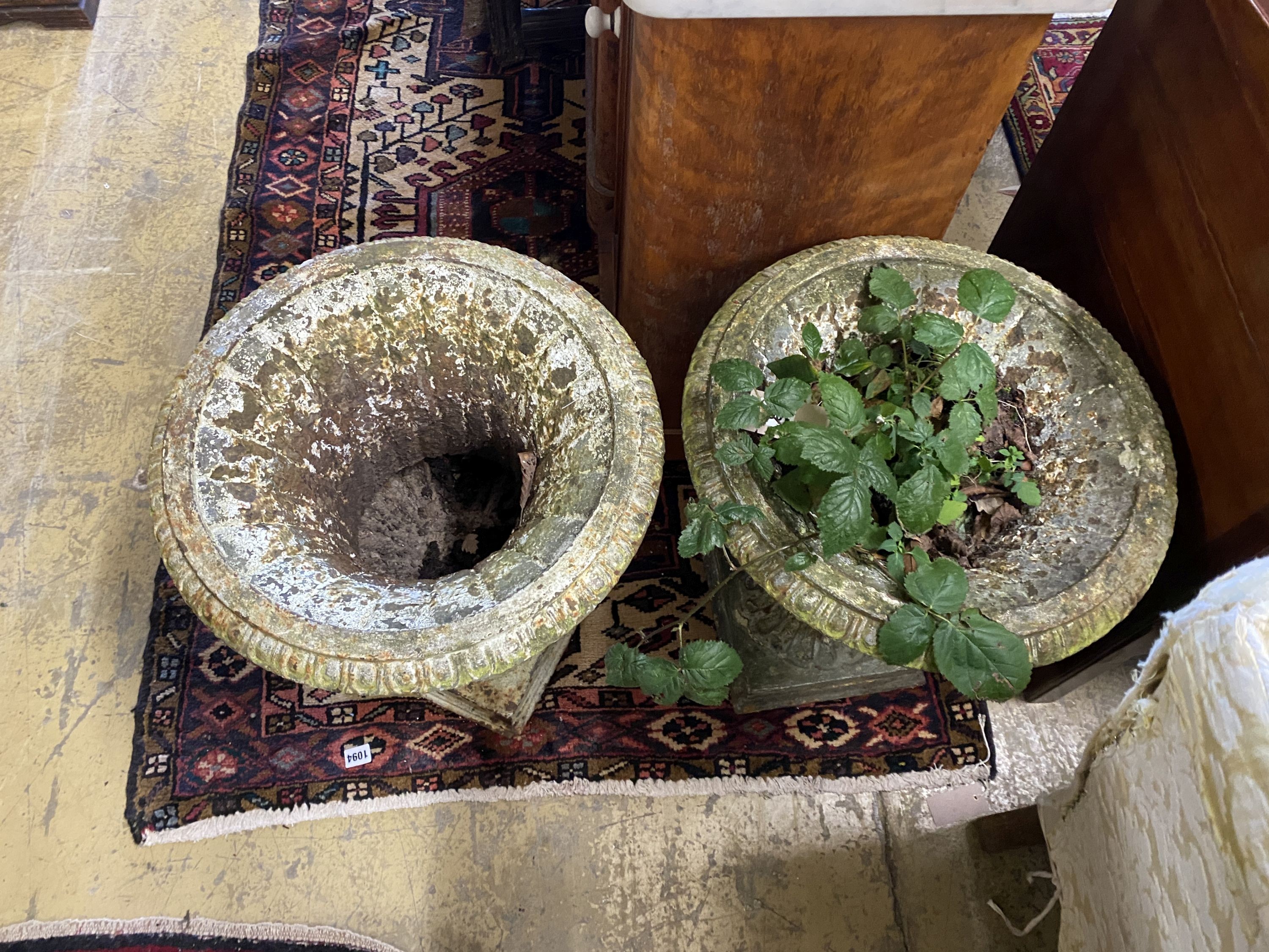 A pair of Victorian painted cast iron campana garden urns, a.f., diameter 44cm, height 50cm